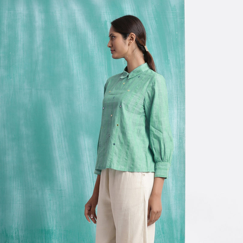 Left View of a Model wearing Ocean Green Handspun 100% Cotton Mirror Work Blouse Top