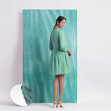 Back View of a Model wearing Ocean Green Handspun Cotton V-Neck Gathered Short Dress