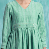 Front Detail of a Model wearing Ocean Green Handspun Cotton V-Neck Gathered Short Dress