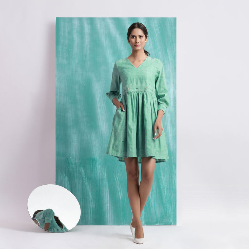 Front View of a Model wearing Ocean Green Handspun Cotton V-Neck Gathered Short Dress