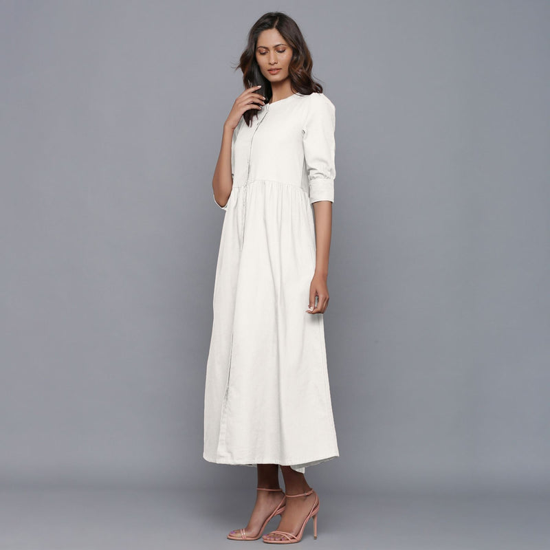 Left View of a Model wearing Off-White Cotton Flannel Gathered Dress