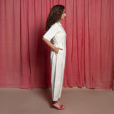 Right View of a Model wearing Off-White Embroidered Cotton Muslin High-Rise Overalls