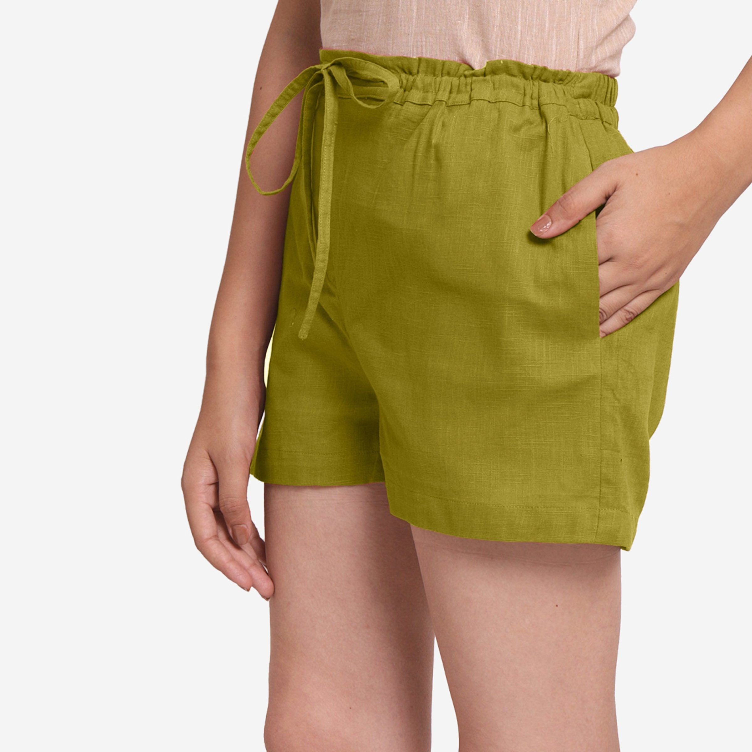 Left View of a Model wearing Olive Green Cotton Straight Shorts
