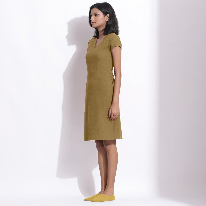 Left View of a Model wearing Olive Green Cotton Waffle V-Neck Dress