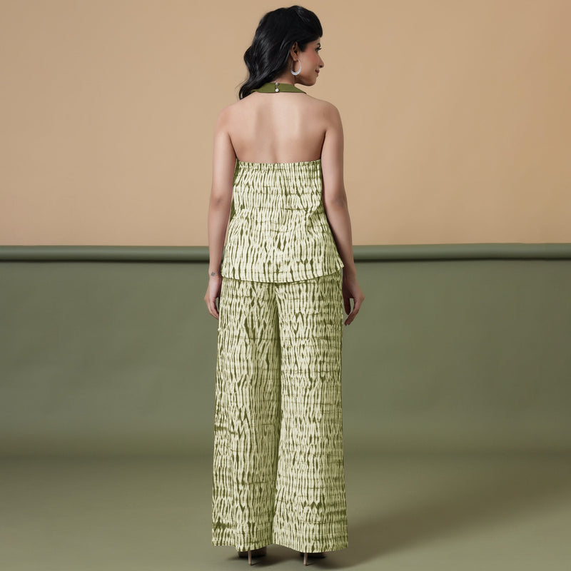 Back View of a Model wearing Olive Green Halter Neck Flared Cotton Top