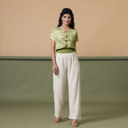 Front View of a Model wearing Olive Green Shibori Button-Down Blouson Top