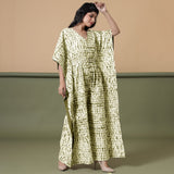 Right View of a Model wearing Olive Green Shibori V-Neck Kaftan Jumpsuit