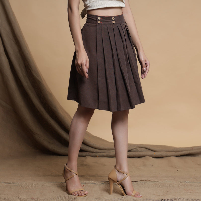 Right View of a Model wearing Orange and Brown Reversible Pleated Flared Skirt