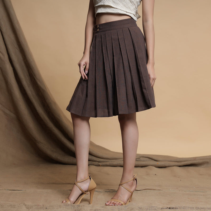 Left View of a Model wearing Orange and Brown Reversible Pleated Flared Skirt