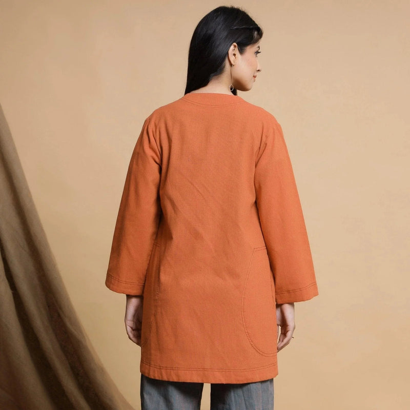 Back View of a Model wearing Orange Cotton High Neck Double Placket Coat