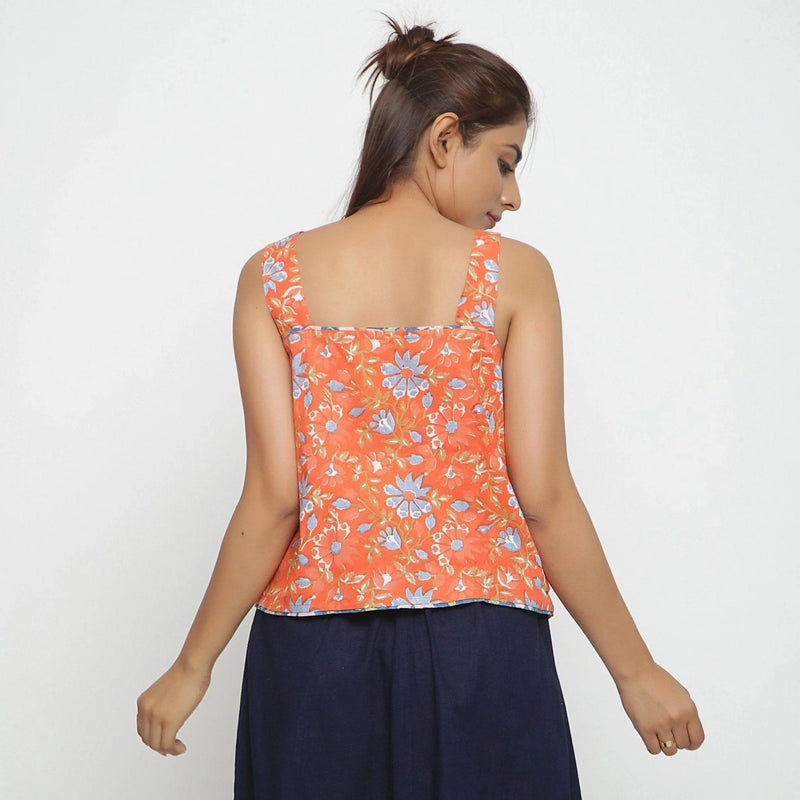 Back View of a Model wearing Orange Floral Block Printed Square Neck Cotton Top