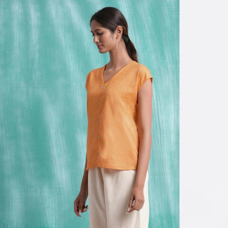 Left View of a Model wearing Orange Hand Mirror Work Drop Shoulder Top