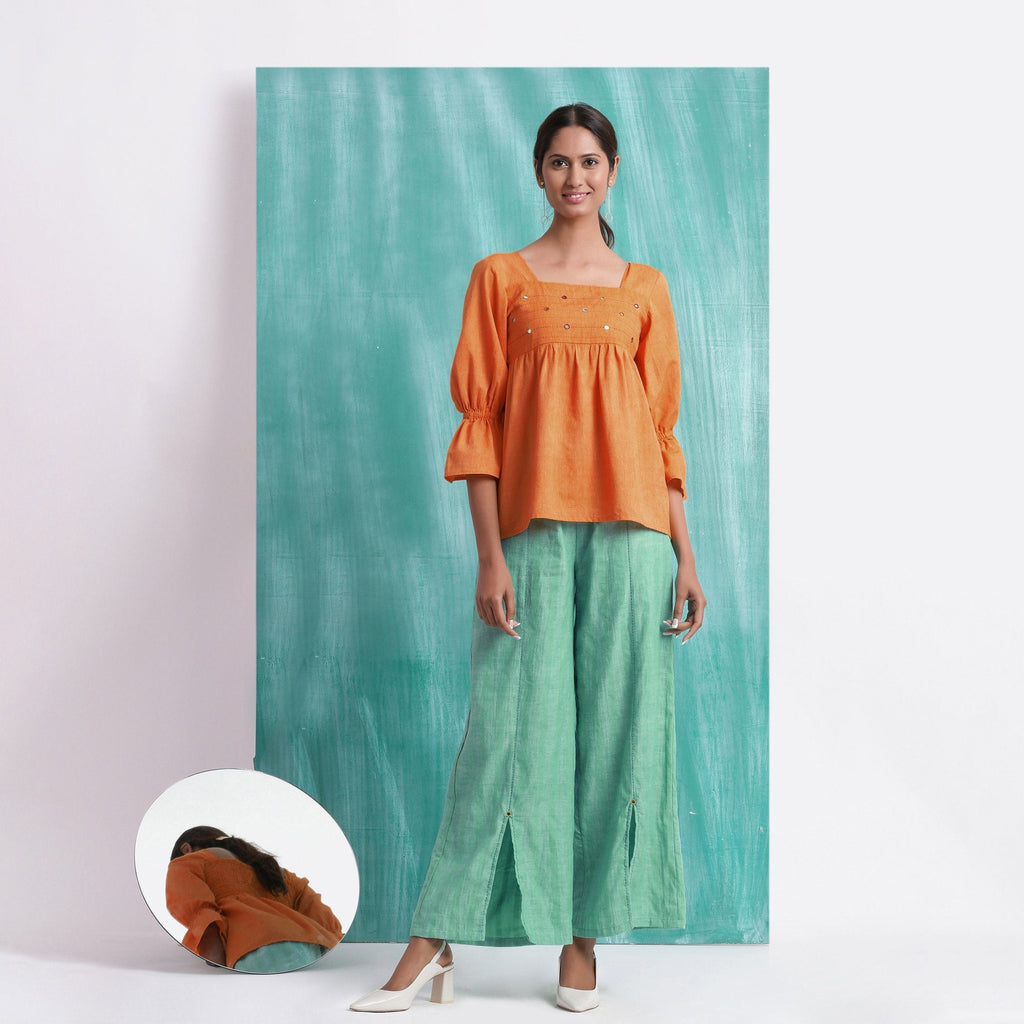 Front View of a Model wearing Orange Handspun Mirror Work Yoked Top
