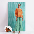 Front View of a Model wearing Orange Handspun Mirror Work Yoked Top