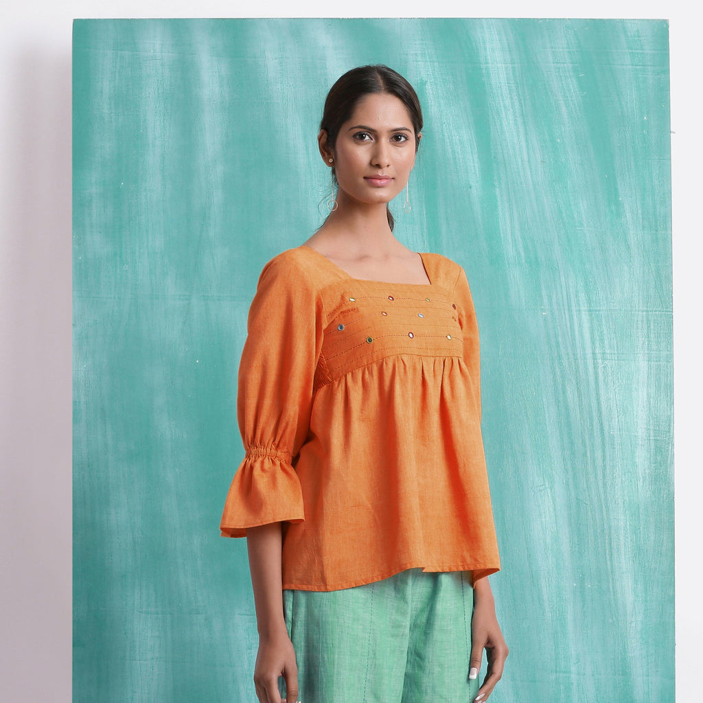 Right View of a Model wearing Orange Handspun Mirror Work Yoked Top