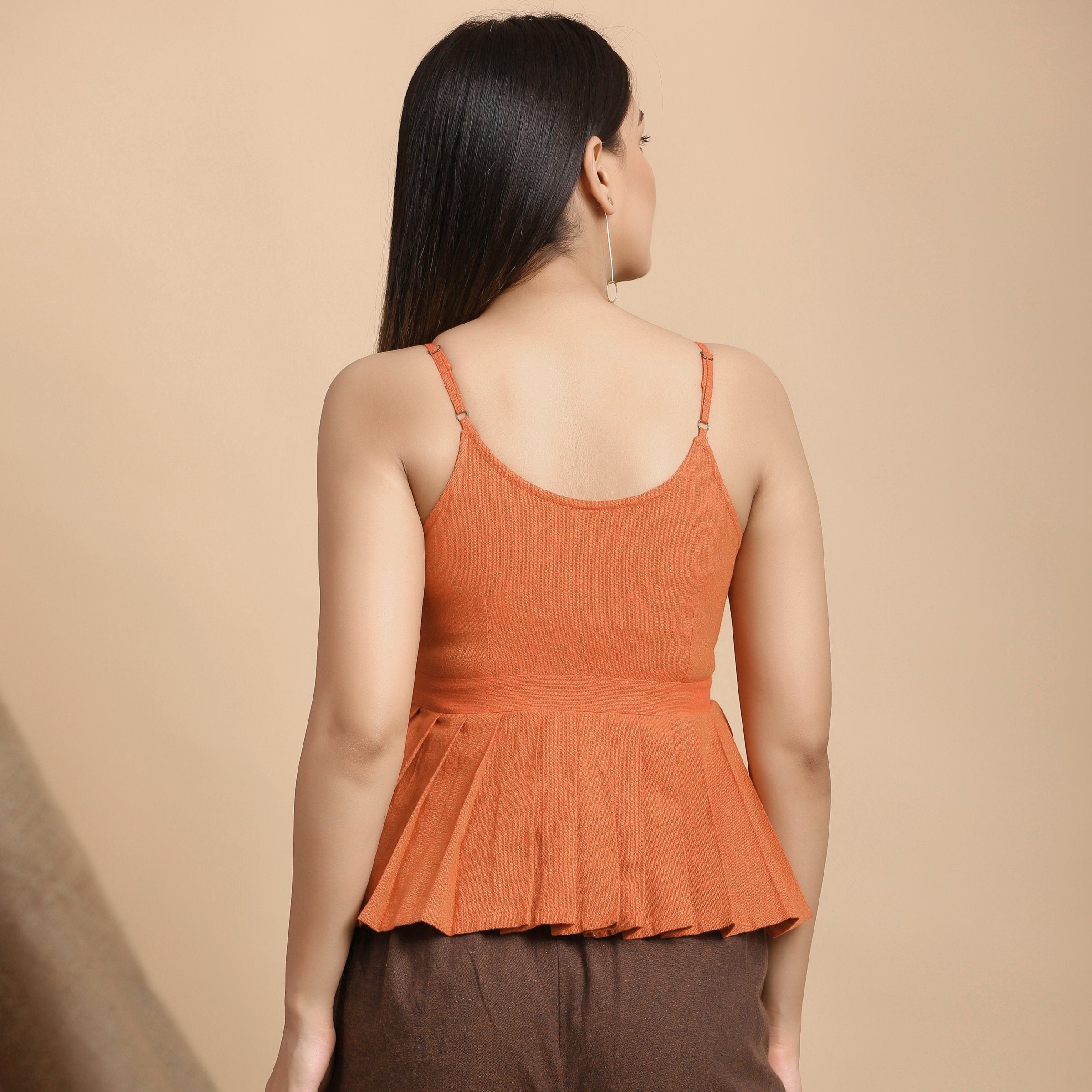 Back View of a Model wearing Orange Pleated Camisole Top