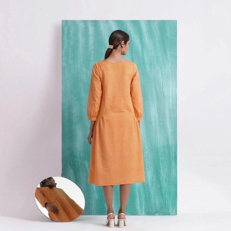 Back View of a Model wearing Orange Comfort Fit Mirror Work Dress