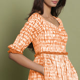 Right Detail of a Model wearing Orange Shibori Asymmetrical Tier Maxi Dress