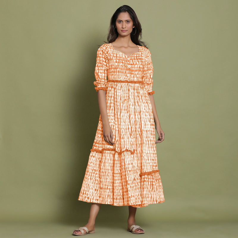 Front View of a Model wearing Orange Shibori Asymmetrical Tier Maxi Dress