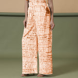 Left View of a Model wearing Orange Shibori Wide Legged Cotton Pant