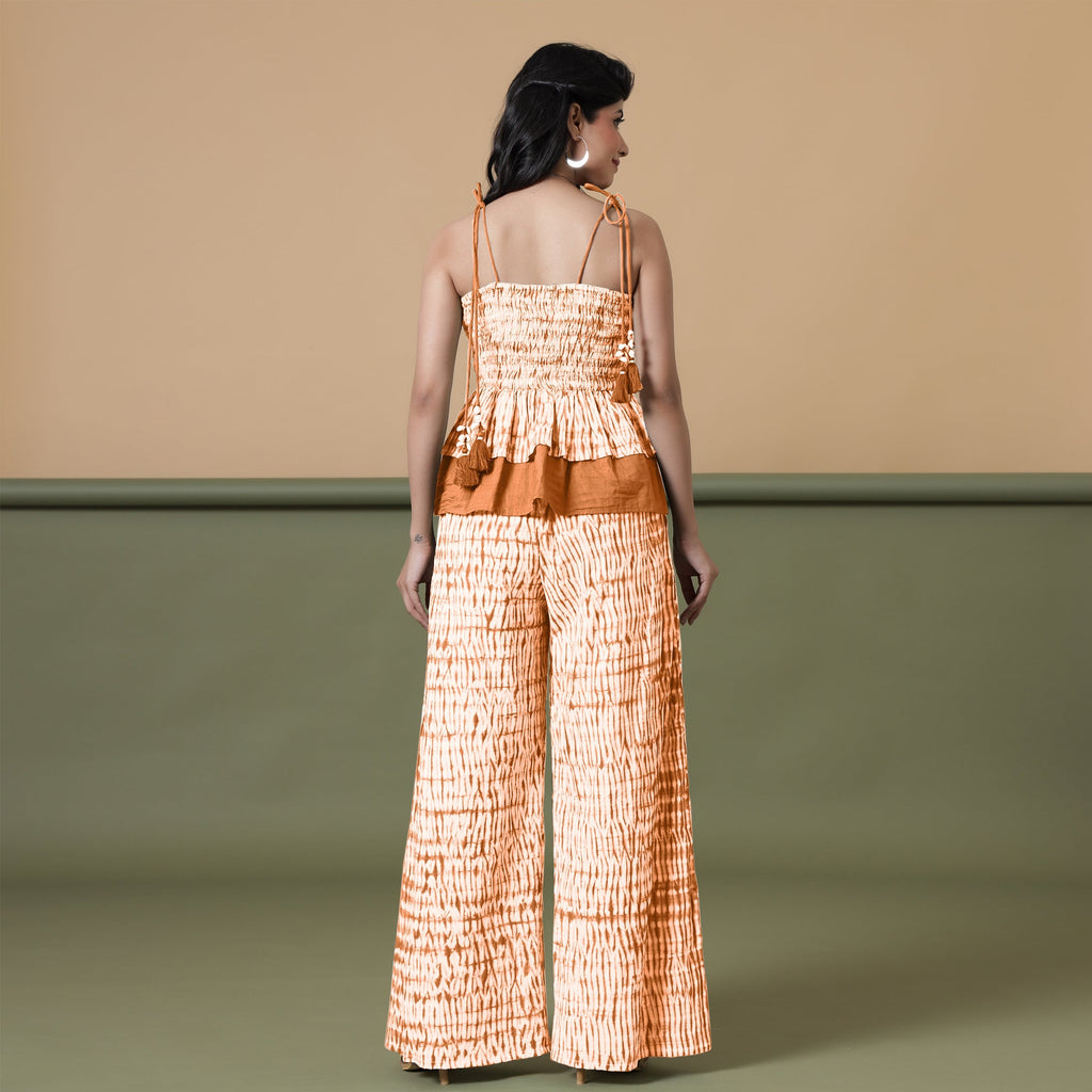 Back View of a Model wearing Orange Shibori Wide Legged Cotton Pant