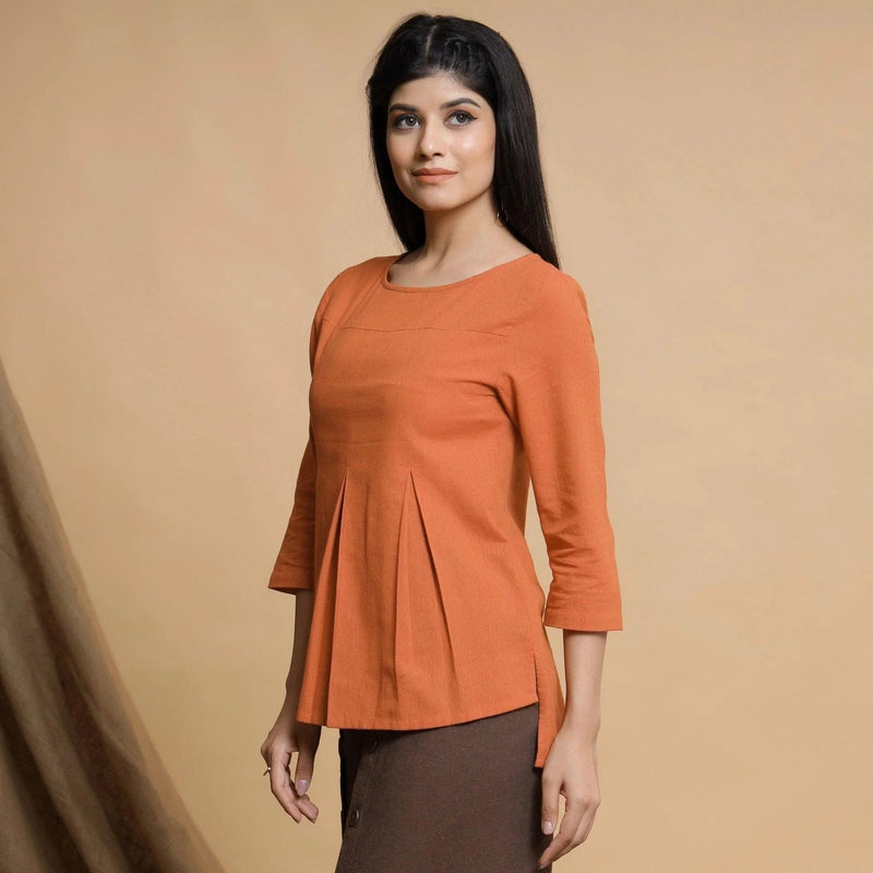 Left View of a Model wearing Orange Yarn Dyed Cotton Pleated High-Low Top