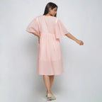 Back View of a Model wearing Peach Lined Cotton Chambray Dress