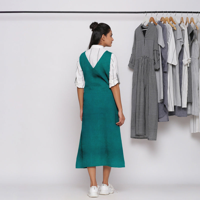 Back View of a Model wearing Pine Green 100% Linen Midi Pinafore Dress