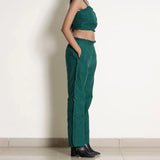 Right View of a Model wearing Pine Green Frill Warm Cotton Mid-Rise Paperbag Pant