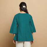 Back View of a Model wearing Pine Green Linen Asymmetrical V-Neck Top