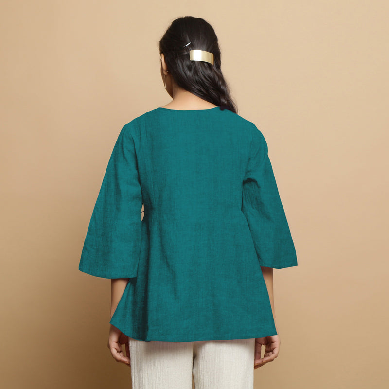 Back View of a Model wearing Pine Green Linen Asymmetrical V-Neck Top