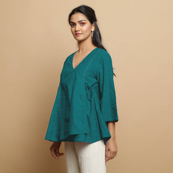 Left View of a Model wearing Pine Green Linen Asymmetrical V-Neck Top