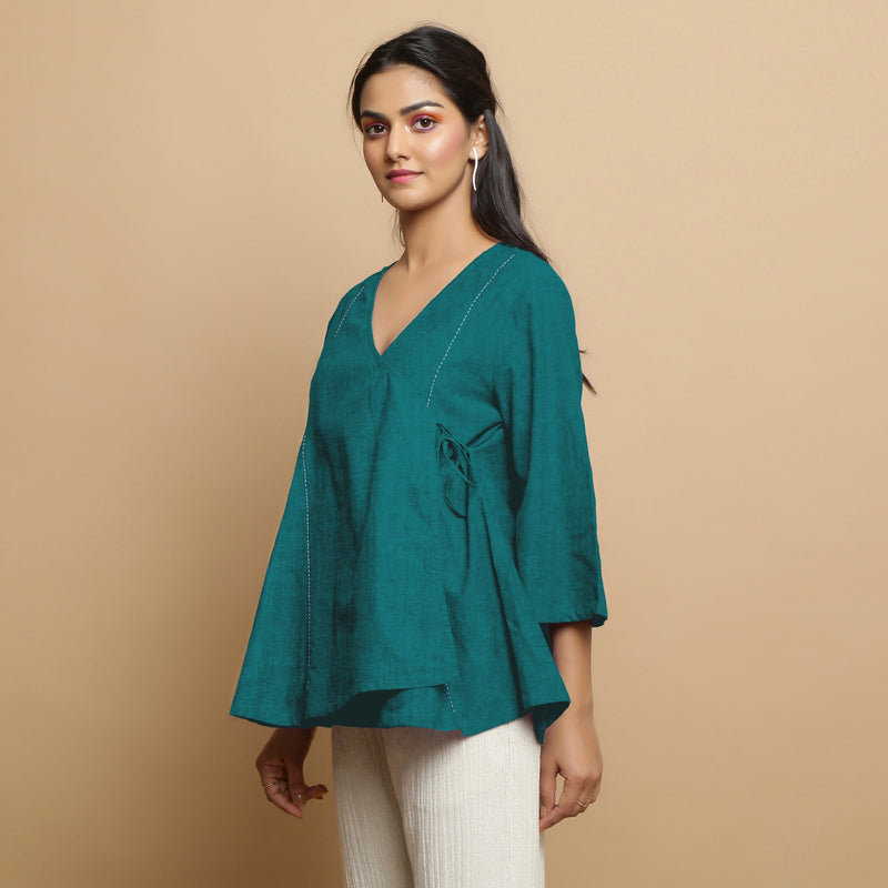 Left View of a Model wearing Pine Green Linen Asymmetrical V-Neck Top