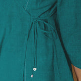 Front Detail of a Model wearing Pine Green Linen Asymmetrical V-Neck Top