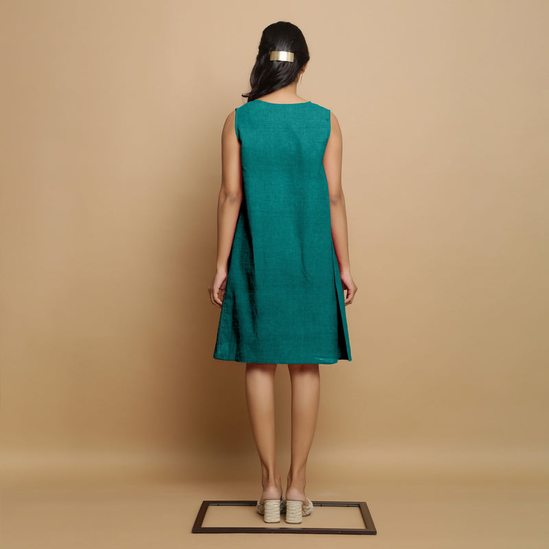 Back View of a Model wearing Pine Green Linen Hand Embroidered Knee-Length Godet Dress