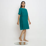 Right View of a Model wearing Pine Green 100% Linen Knee Length Yoked Dress