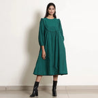 Front View of a Model wearing Pine Green Warm Cotton Frilled Midi Yoke Dress
