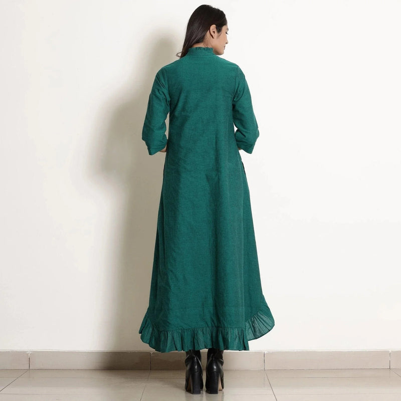 Back View of a Model wearing Warm Pine Green Frilled Neck High Low Dress