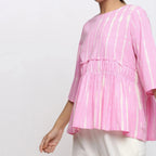 Left Detail of a Model wearing Pink Cotton Tie-Dye Cotton Gathered Flared Top