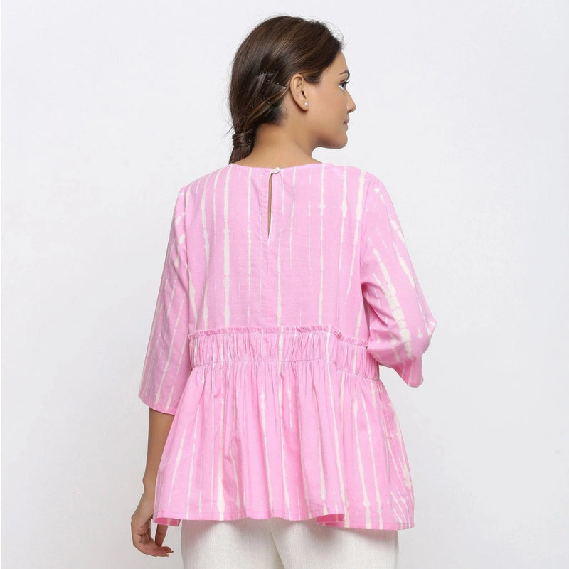 Back View of a Model wearing Pink Cotton Tie-Dye Cotton Gathered Flared Top