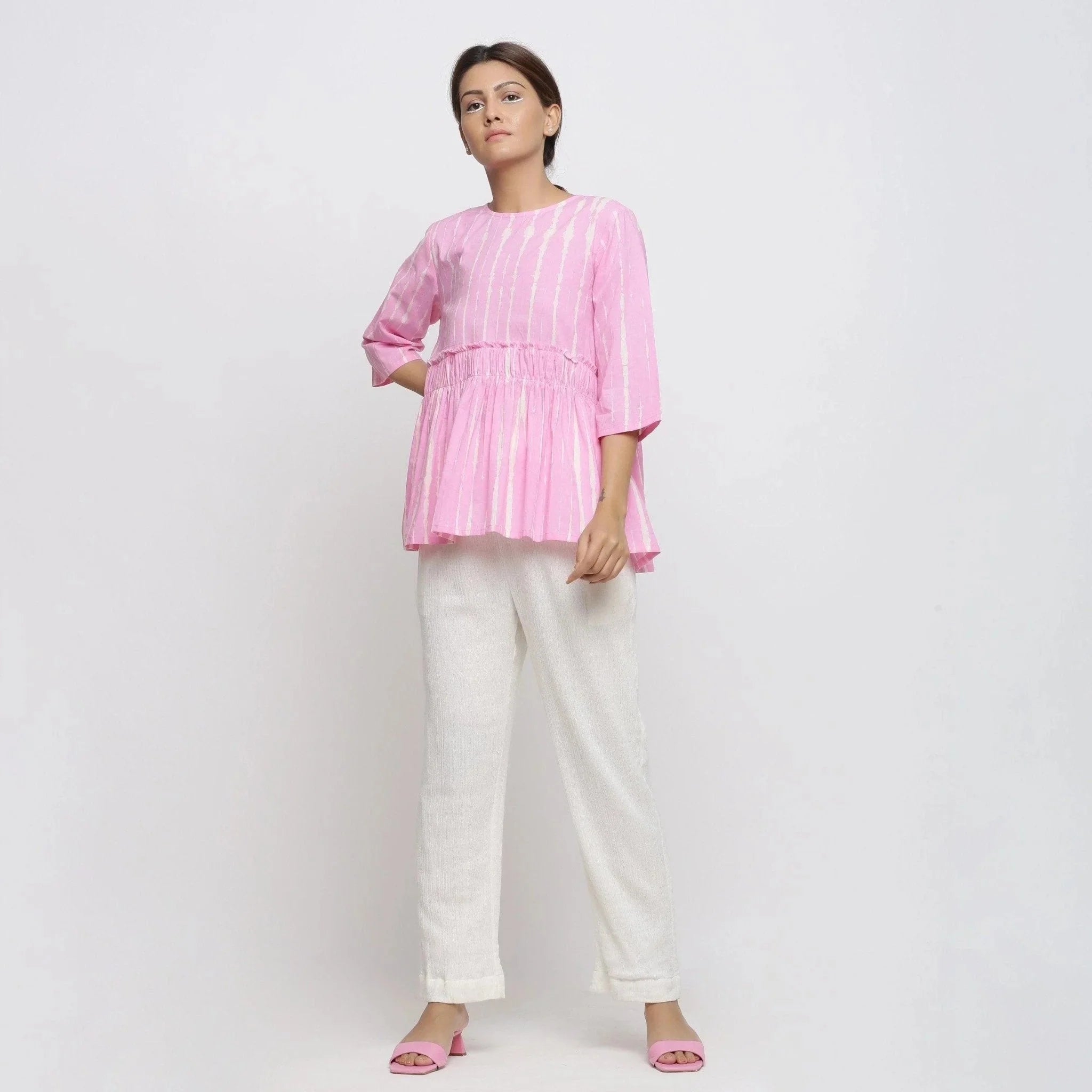 Front View of a Model wearing Pink Cotton Tie-Dye Cotton Gathered Flared Top