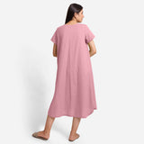 Back View of a Model wearing Pink Cotton Welt Pocket Shift Dress