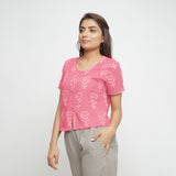 Left View of a Model wearing Pink Dabu Floral Block Print Button-Down Cotton Top