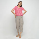 Front View of a Model wearing Pink Dabu Floral Block Print Button-Down Cotton Top