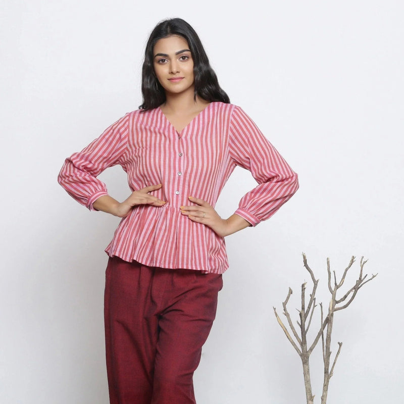 Front View of a Model wearing Pink Handspun Button-Down Peplum Top