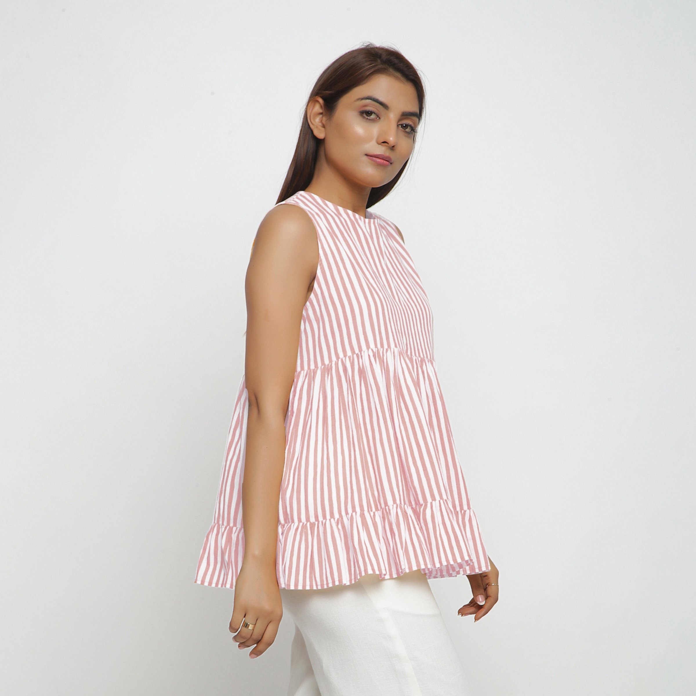 Left View of a Model wearing Pink Tiered Hand Screen Printed Top