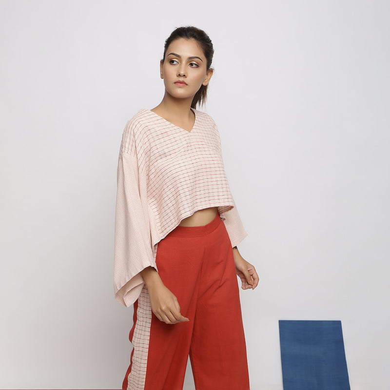 Right View of a Model wearing Beige and Pink Vegetable Dyed Handspun Cotton V-Neck Crop Top