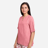 Left View of a Model wearing Pink Yarn Dyed Cotton High-Low Top