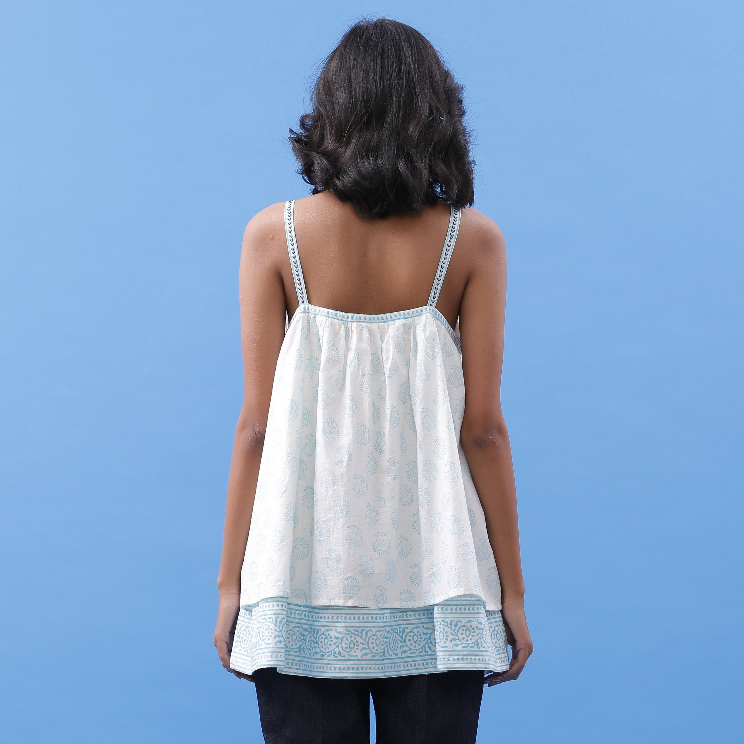 Back View of a Model wearing Powder Blue Block Printed V-Neck Tunic Top