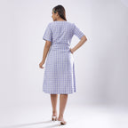 Back View of a Model wearing Powder Blue Handspun Plunge Neck Wrap Dress
